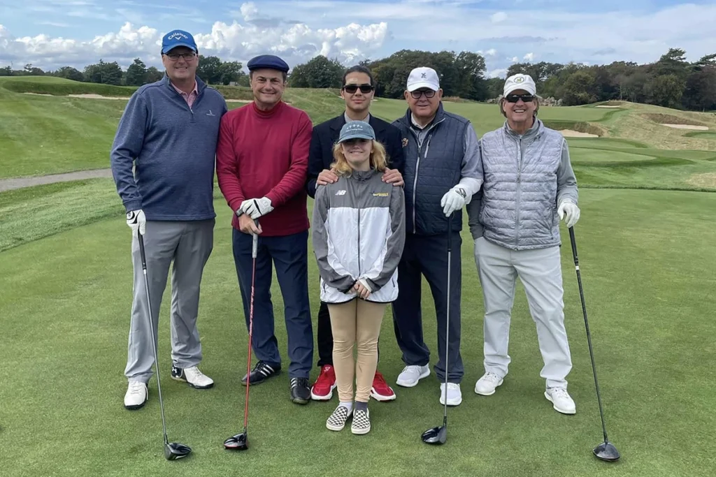 Group of players posing at annual golf tournament