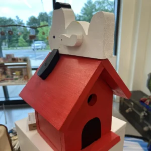 Hand-made red birdhouse with dog