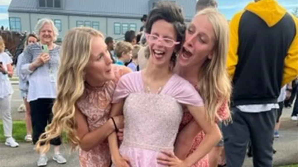 Cushing student poses for prom pictures in her dress.