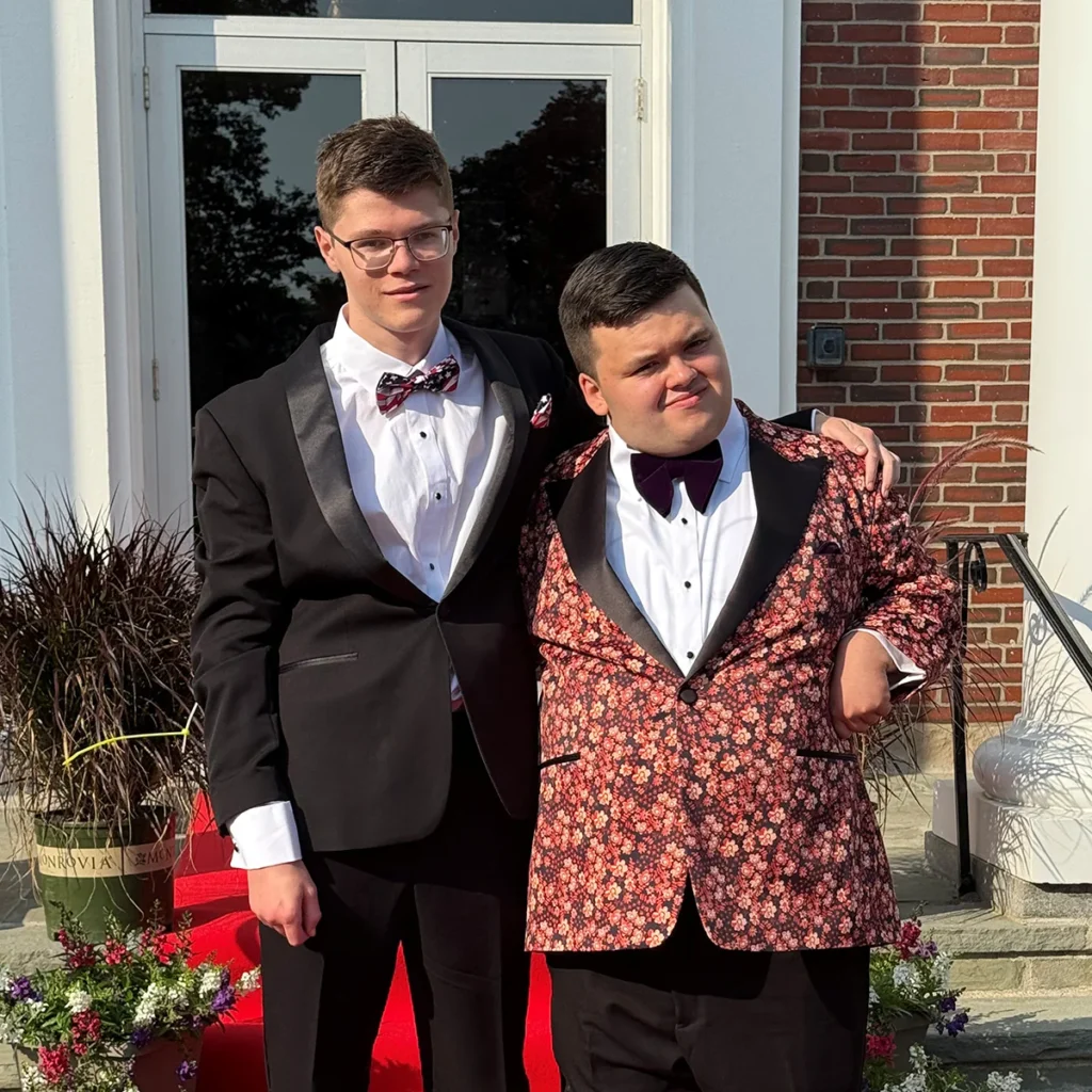 Two students posing in tuxedos