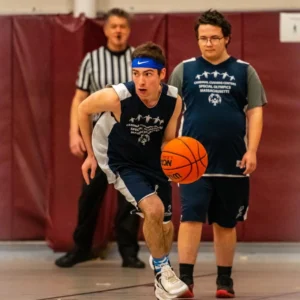 Athlete playing basketball at MA Special Olympics
