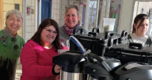 Eleanor Arpino, student Bella Testa, Sue Svelnis and Samantha Babineau roll out the new coffee cart.