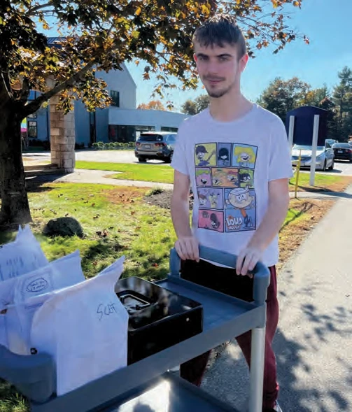 Student DJ Russ delivers orders from the café