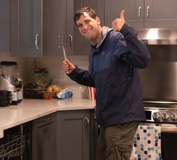 Ari Tannenbaum smiling in the new kitchen.