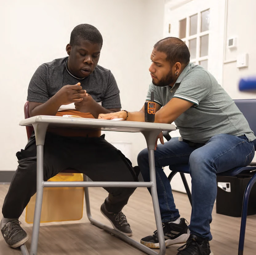 Student Caleb Charles working with staff member Alvaro Gomez-Cruz.