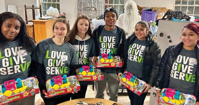 A group from Spellman organizing toys for a Toys for Tots drive.