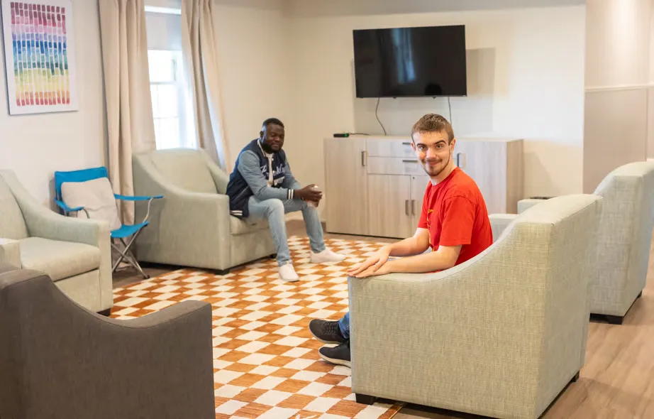 Marquis Baptiste and DJ Russ relax in the
living room.