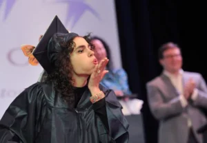 Jessica Rowe sends a kiss to her parents during the Cardinal Cushing Centers' graduation in Hanover on Saturday, June 14, 2025.
