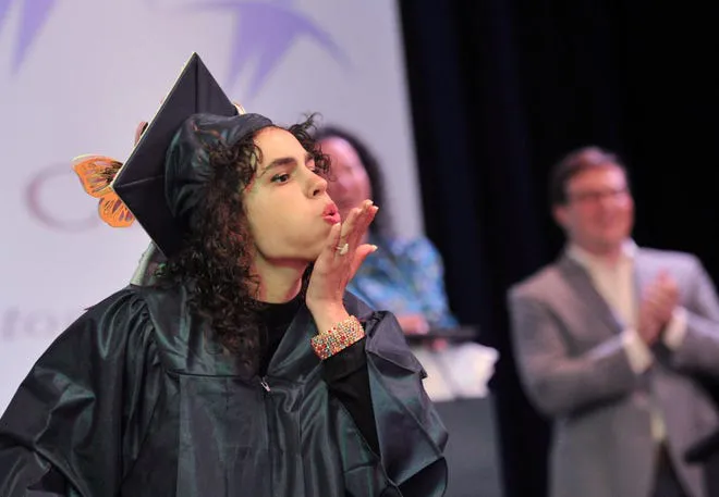Jessica-Rowe Jessica Rowe sends a kiss to her parents during the Cardinal Cushing Centers' graduation in Hanover on Saturday, June 14, 2025.