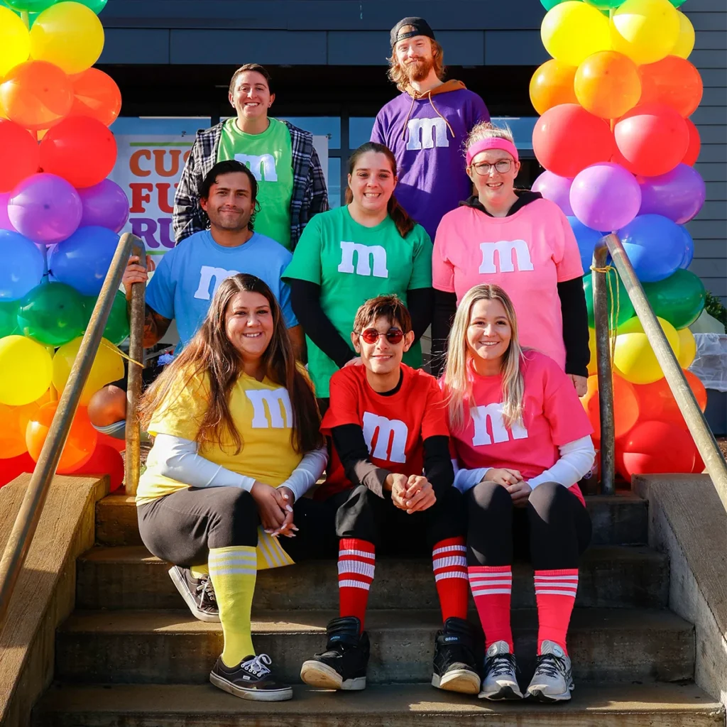 Cushing student and family pose for photos dressed as M&M's at Cushing's 2nd Annual Fun Run October, 2024
