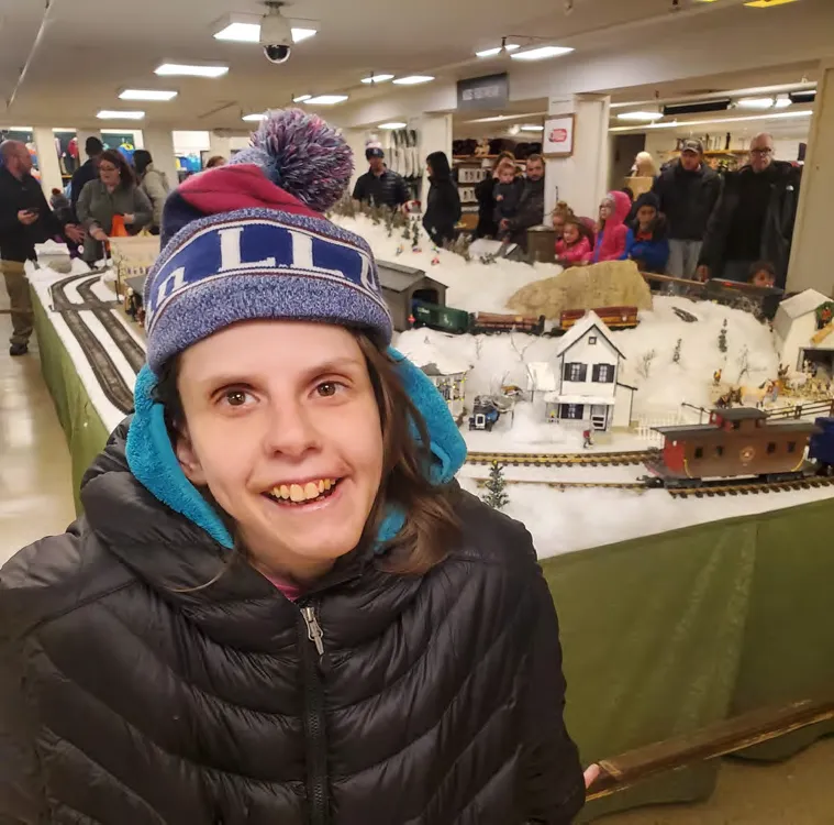 Courtney Schleicher in front of a miniature train display