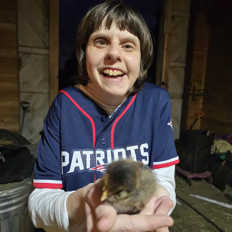 Courtney Schleicher holding a chick