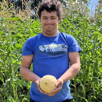 James Tamblyn shows off a cantaloupe he picked.