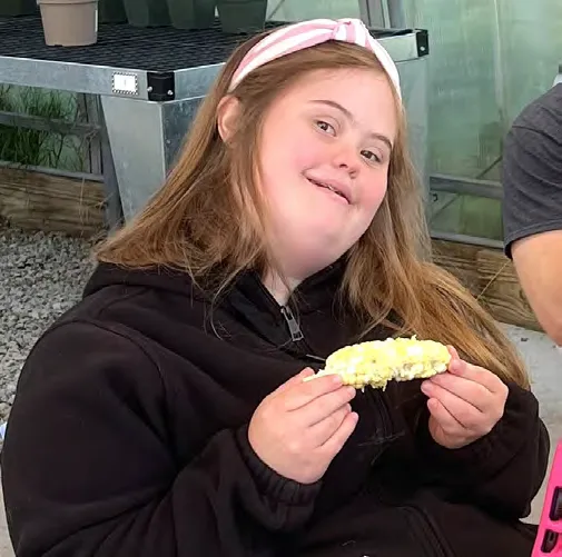 Moriah Winchell enjoys freshly picked corn.
