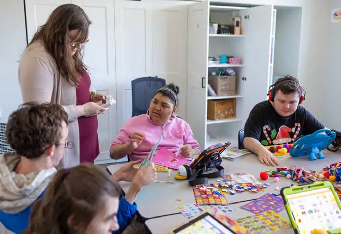 Hannah Meallo helps students Anaya Figueroa and Mason Austin.