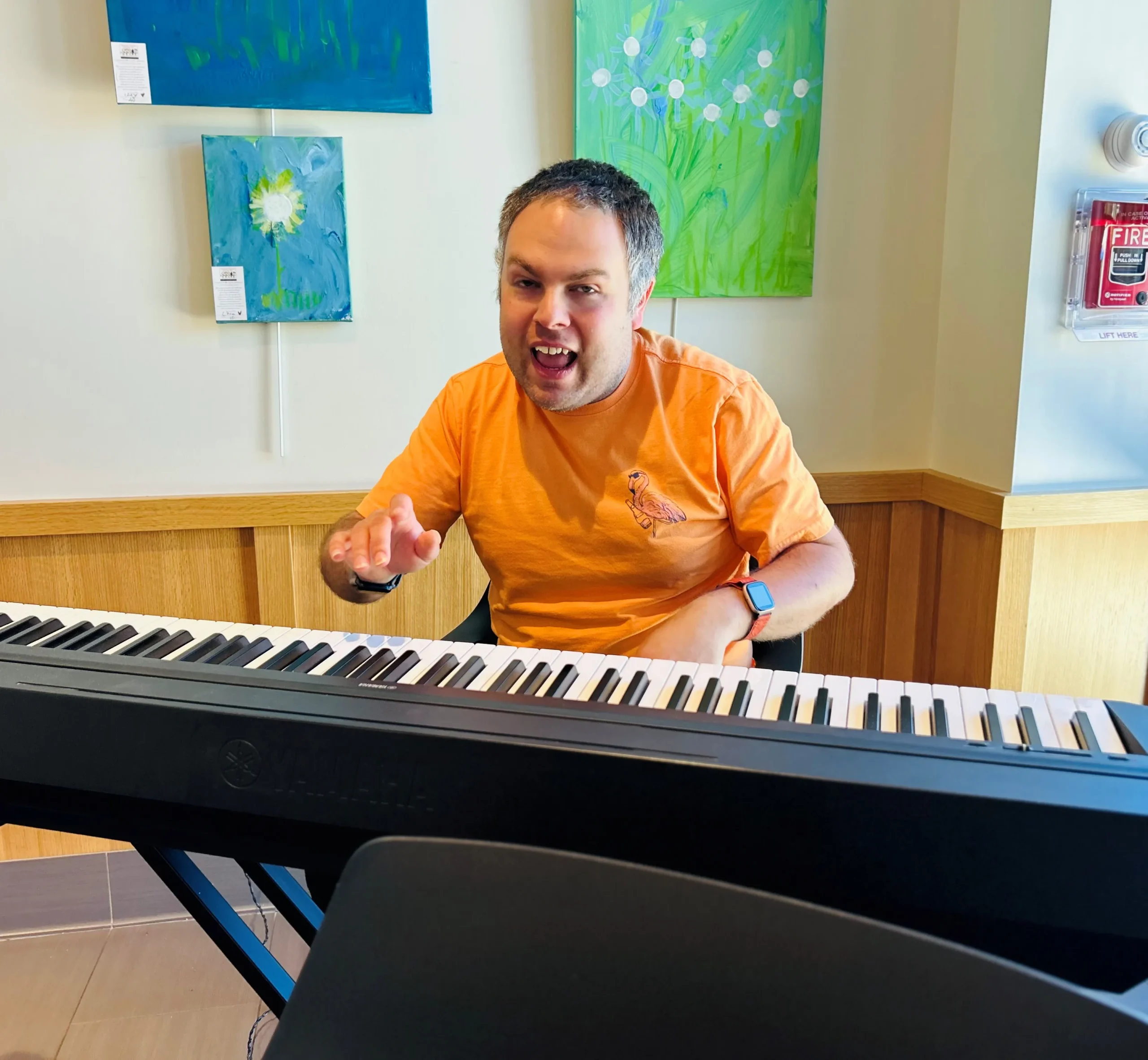 Lee Rasiel smiling at a piano