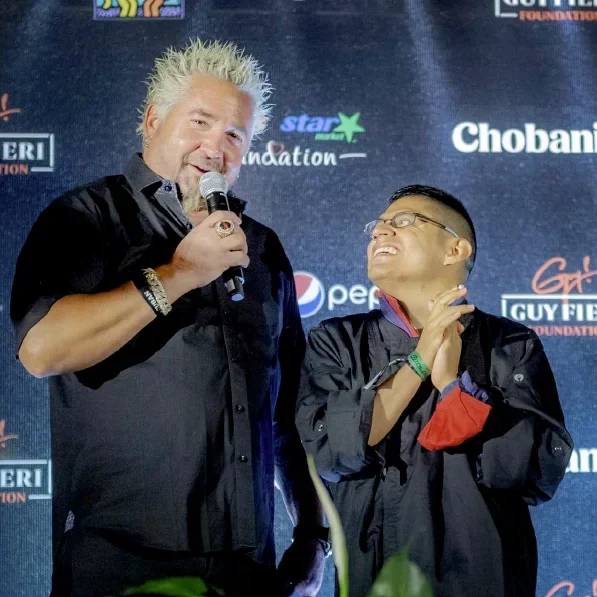 Guy Fieri and Michael Jaxtimer Barry on stage